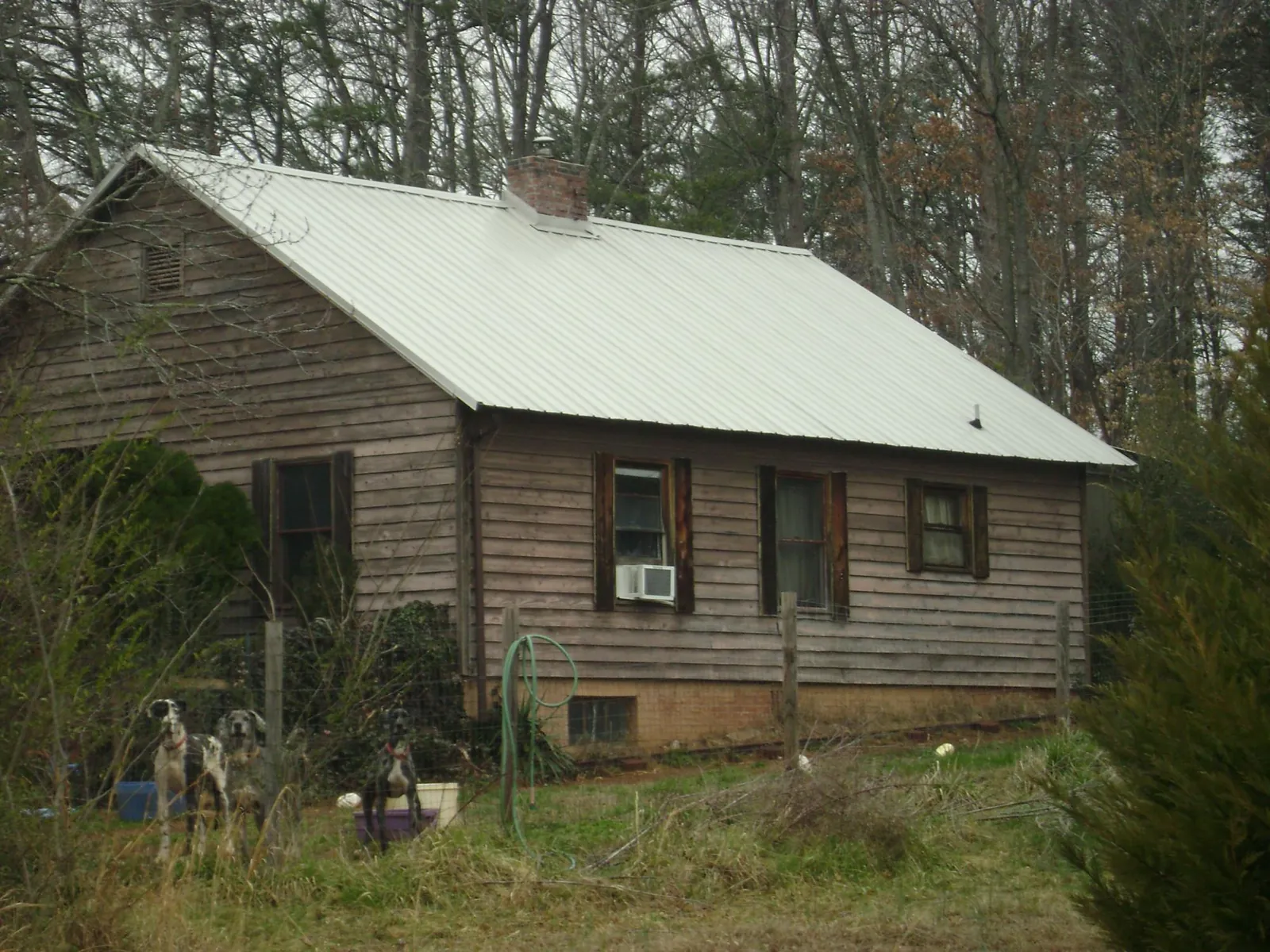 White metal roof on an old wood sided farmhouse, from a Asphalt Shingle Roof Repair job in Shirleysburg